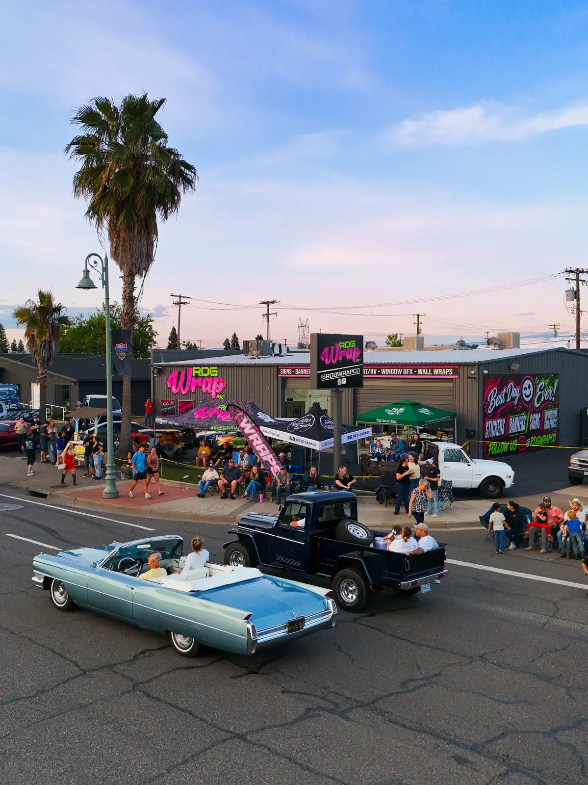 Drone view of classic cars cruising past the shop during Kool April Nights